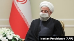 IRAN -- A handout picture provided by the Iranian presidency on August 26, 2020 shows President Hassan Rouhani meeting with the Director General of the International Atomic Energy Agency (IAEA) in Tehran