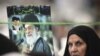 A woman holds a picture of Supreme Leader Ayatollah Ali Khamenei while attending Friday Prayers at Tehran University, which hosted the National Soft War Forum.