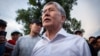 Ex-President Almazbek Atambaev speaks to supporters outside his home near Bishkek on June 27. 