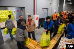 Volunteers pack food parcels inside the Donbas Stadium in Donetsk. (file photo)