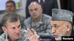 Afghan President Hamid Karzai (right) speaking with General Stanley McChrystal on April 10, 2010 in Kabul