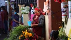 Žene sa zaštitnim maskama prodaju cvijeće na marketu, San Bartolome Quialana, Meksiko, juni 2020.