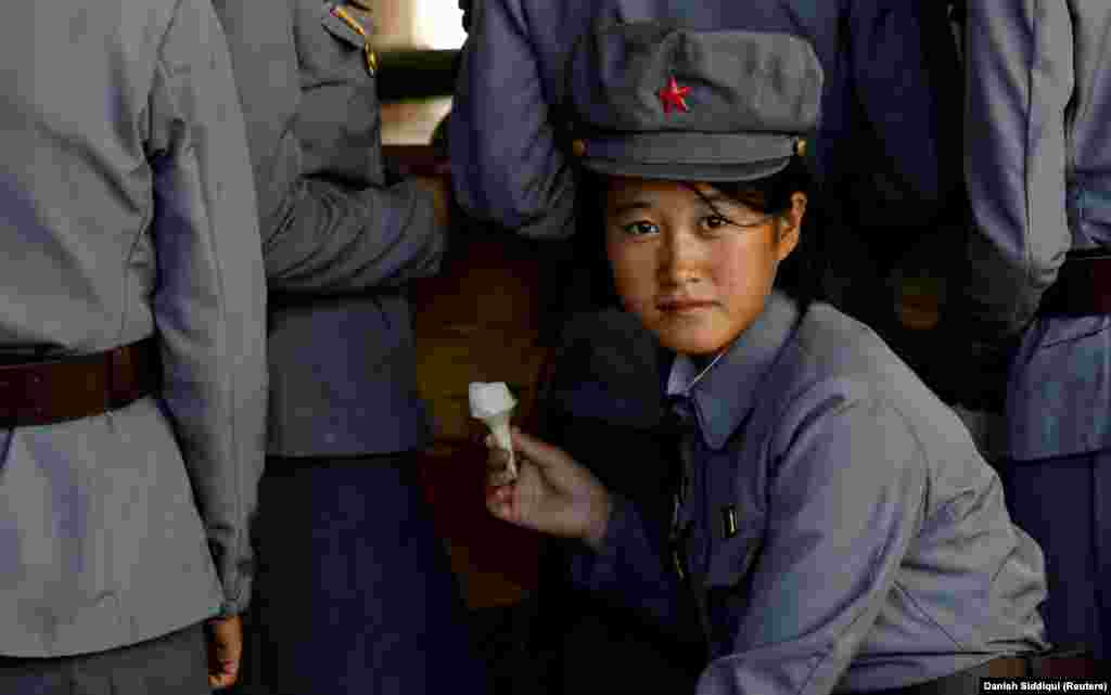 A young North Korean soldier eats ice cream as she visits a zoo in Pyongyang on September 12, 2018.&nbsp;