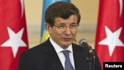 Kazakhstan - Turkey's Foreign Minister Ahmet Davutoglu speaks during a news briefing with Kazakhstan's Foreign Minister Yerlan Idrisov in Almaty, 26Apr2013