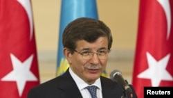 Kazakhstan - Turkey's Foreign Minister Ahmet Davutoglu speaks during a news briefing with Kazakhstan's Foreign Minister Yerlan Idrisov in Almaty, 26Apr2013