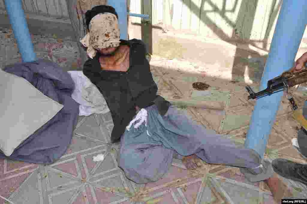 A suspected militant being held by Afghan security forces in Kunduz.