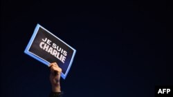 France -- A man holds a placard reading "I am Charlie" on the Old Harbor in Marseille, January 7, 2015