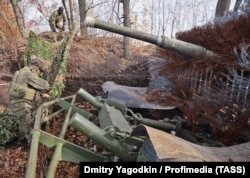 Russian soldiers with a tank fitted with hedgehog armor in Ukraine's Donetsk region in November