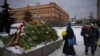 People lay flowers to pay last respects to Aleksei Navalny at the Solovetsky Stone, a monument to political repression, in Moscow on February 17. 