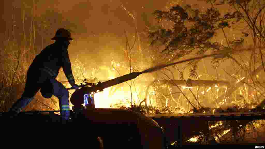 A Montenegrin firefighter battles a wildfire on the outskirts of Podgorica on July 17. (REUTERS/Stevo Vasiljevic)