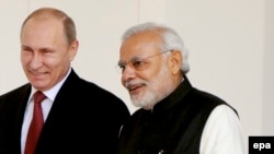 Indian Prime Minister Narendra Modi (R) walks with Russian President Vladimir Putin before their meeting in New Delhi on December 11.