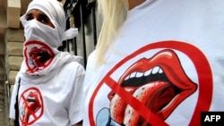 Young activists of the Freedom of the Press group wear T-shirts with their logo as they give out leaflets in Kyiv. Freedom House found a "significant decline" in press freedom in Ukraine.