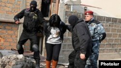 Armenia - Security forces detain a woman in a raid on a house in Yerevan's Nork district, 25Nov2015.