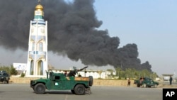 FILE: Afghan security forces at the site of a bomb attack outside the provincial police headquarters in Kandahar, July 2019.