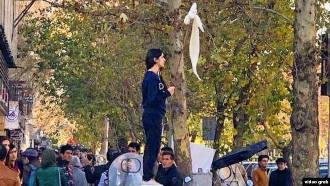 Iranian women have been removing their head scarves in public and waving them on sticks as a sign of protest.