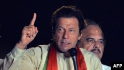 Pakistani opposition politician Imran Khan addresses supporters during a protest march against the country's Pakistan Muslim League-Nawaz-led government in Pakistan's capital, Islamabad, on August 18.