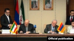 Iran - Energy Minister Hamid Chitchian (L) and his Armenian counterpart Yervand Zakharian sign a memorandum of understanding in Tehran, 16Dec2014.