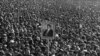 Protesters hold a portrait of Ayatollah Ruhollah Khomeini during the 1979 revolution.