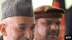 Afghan President Hamid Karzai (left) and Mohammad Qasim Fahim, one of his vice presidential choices, at the Independent Election Commission in Kabul on May 4.