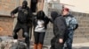 Armenia - Security forces detain a woman in a raid on a house in Yerevan's Nork district, 25Nov2015.