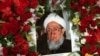 The portrait of former Afghan President Sibghatullah Mojaddedi is seen in the wreath of flowers during his funeral procession at the presidential palace in Kabul, February 13, 2019