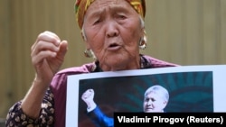 A supporter of Almazbek Atambaev attends a rally outside the State Committee for National Security in Bishkek on August 16.