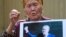 A supporter of Almazbek Atambaev attends a rally outside the State Committee for National Security in Bishkek on August 16.