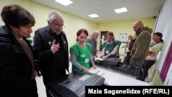 Georgians vote at a polling station in Tbilisi on October 26.