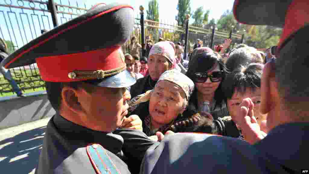 Supporters of detained Kyrgyz opposition lawmakers clash with police in front of the government headquarters in Bishkek. (AFP/Vyacheslav Oseledko)