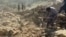 Afghanistan - Afghans clean up rubble left by Pakistani air strikes in Kunar Province on October 1 - AFP screen grab