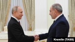 RUSSIA -- Russian President Vladimir Putin (L) shakes hands with Armenian Prime Minister Nikol Pashinian before a meeting with leaders of Armenia and Azerbaijan over the Nagorno-Karabakh's future at the Kremlin in Moscow, January 11, 2021