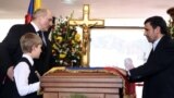 Venezuela -- Iranian President Mahmud Ahmadinejad (R), Belarusian President Alyaksandr Lukashenka (L) and his son Nikolay paying their last respects to the coffin of late President Hugo Chavez in Caracas, 08Mar2013