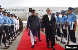 Iranian President Masud Pezeshkian (center right) arrives to attend a BRICS summit in New Delhi on September 11.