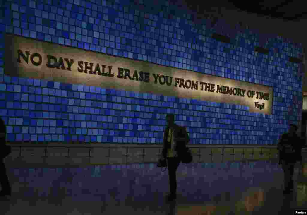 A memorial wall featuring panels for the 2,983 victims of the attacks
