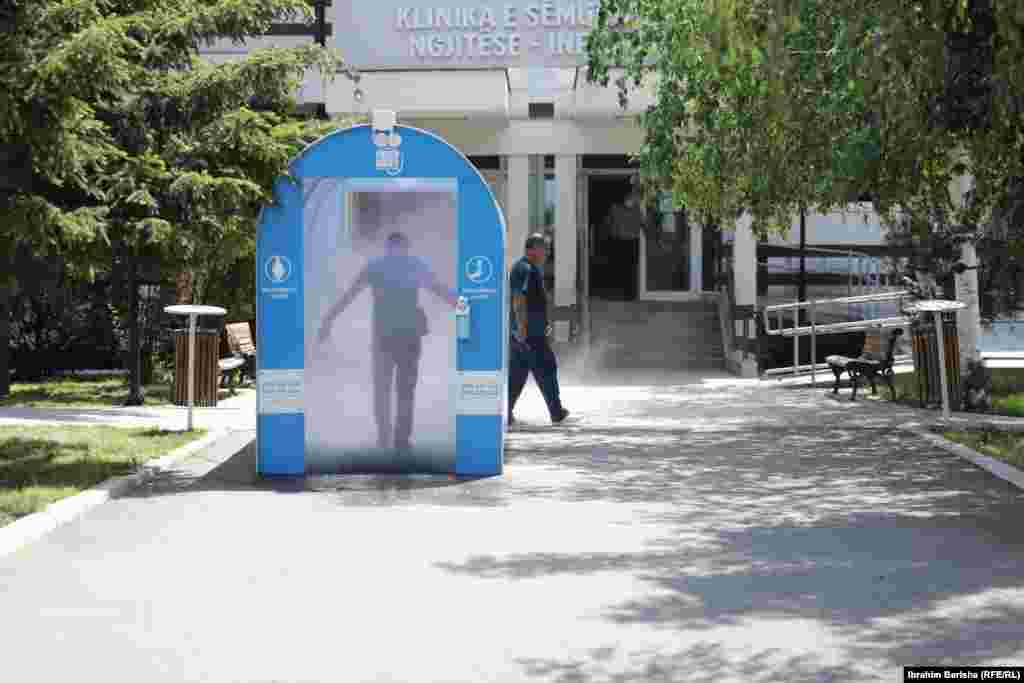 Një qytetar në tunelin dezinfektues pranë Klinikës Infektive në Prishtinë.