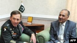 Pakistani Defense Minister Ahmed Mukhtar (right) meets with U.S. General David Petraeus in Rawalpindi.