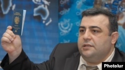 Armenia -- The head of the police Department on Passports and Visas, Hovannes Kocharian, shows a sample biometric passport to reporters at a press conference in Yerevan, 21May2012.