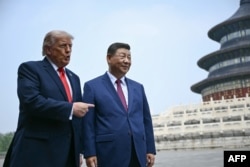 US President Donald Trump (left) with Chinese President Xi Jinping in Beijing on May 14.