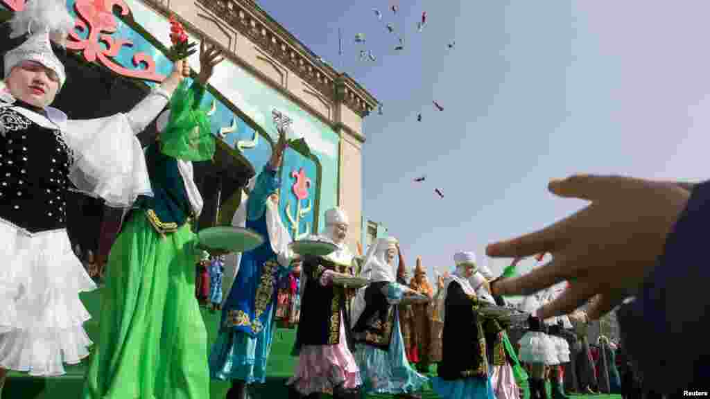 Spectators try to catch sweets thrown to the public during a Norouz (New Year) celebration in Almaty, Kazakhstan, on March 21. (Reuters/Shamil Zhumatov)