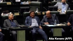 Abdolnaser Hemmati (center), Governor of the Central Bank of Iran, listens to a speech over the a bill to counter terrorist financing in parliament in Tehran, October 7, 2018