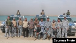 Nature Iraq’s Omar Fadhel (center) and his colleagues are accompanied by troops on a recent survey in western Iraq.