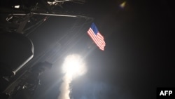 An image released by the U.S. Navy shows the guided-missile destroyer USS Porter conducting cruise-missile strikes against the Shayrat Airfield in Syria on April 7.