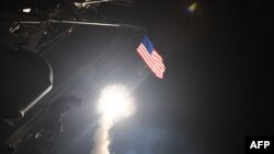 An image released by the U.S. Navy shows the guided-missile destroyer USS Porter conducting cruise-missile strikes against the Shayrat Airfield in Syria on April 7.