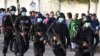 Police officers wear masks amid coronavirus fears as they guard Pakistan Super League cricket matches outside the National Stadium in Karachi on March 12.