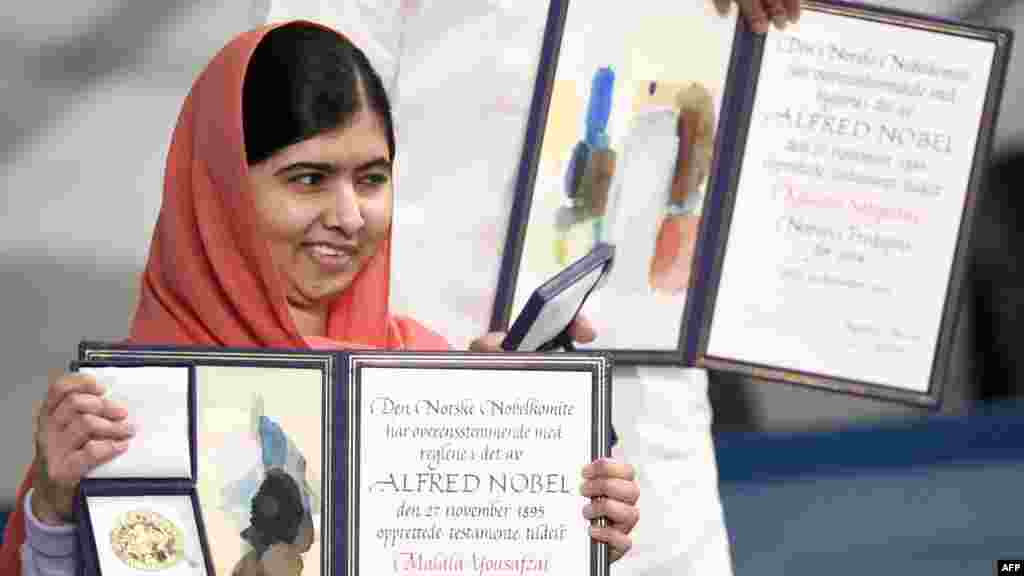 Yousafzai holds her Nobel Peace Prize at the award ceremony in Oslo on December 10, 2014.