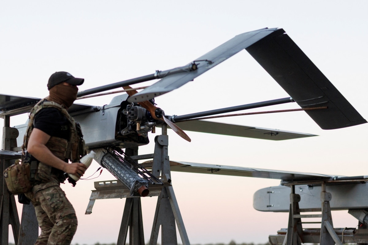 A serviceman of Ukraine's 414th Separate Unmanned Systems Brigade, Birds of Magyar, checks a long-range FP-1 strike drone before launching it on a combat mission. Location undisclosed, Ukraine, 2026.