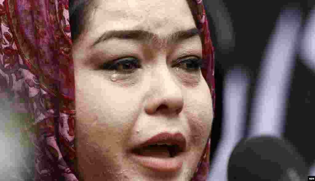 An Afghan woman cries as she condemns the killings.