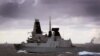 At Sea -- HMS Duncan (C) monitors the Russian battle cruiser Peter the Great (L) and aircraft carrier Admiral Kuznetsovon as they proceed through the North Sea, October 20, 2016