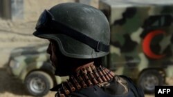 Afghanistan -- An Afghan security force stands guard as a ambulance arrive near entrance gate of the Presidential palace in Kabul, 25Jun2013