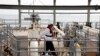 IRAN -- An Iranian laborer walking the platform of the oil facility in the Khark Island, on the shore of the Gulf, March 12, 2017 